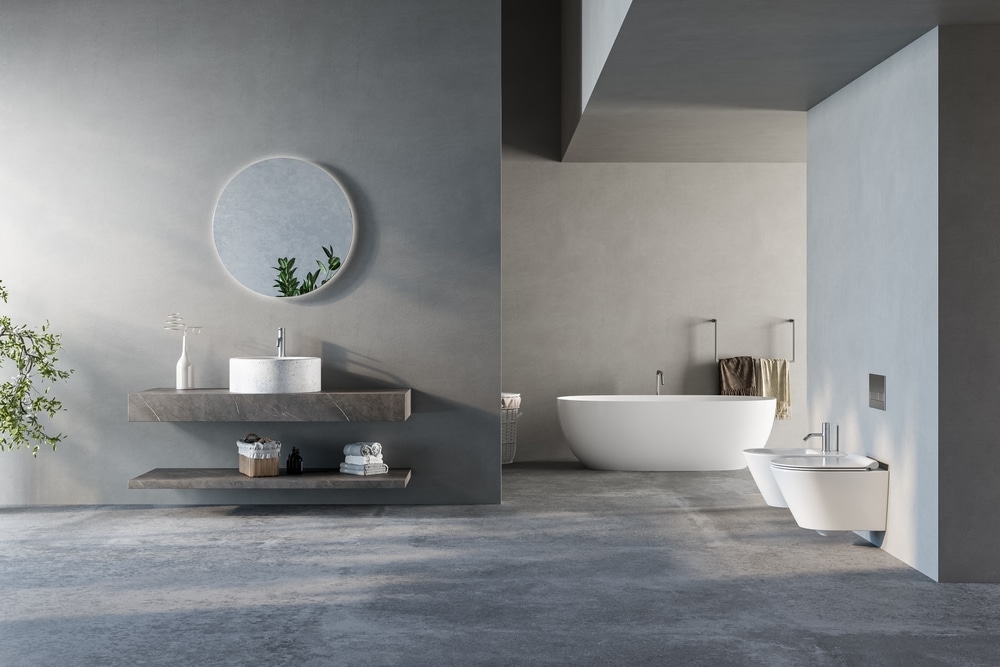 Salle de Bain Minimaliste Moderne Grise au Design Épuré Salle de bain minimaliste grise avec miroir rond, vasque et baignoire îlot blanche design.